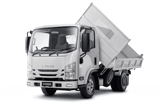 Small white tipper truck unloading cargo
